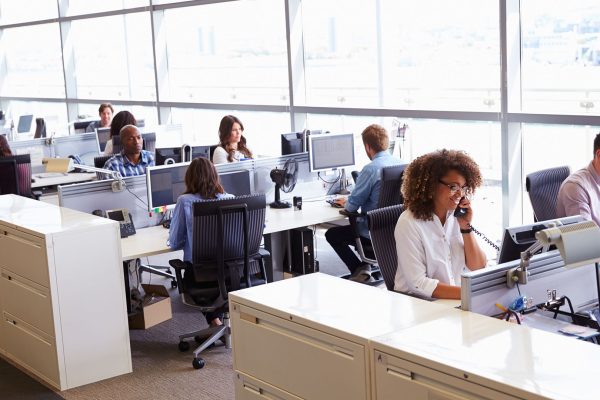 Casually dressed workers in a busy open plan office